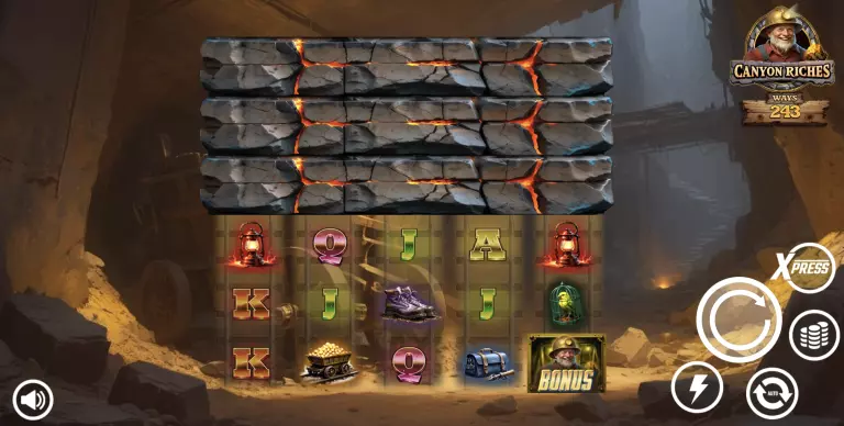 Canyon Riches slot game screen featuring 243 ways to win, with mining-themed symbols like lanterns, gold carts, boots, and bonus icons, set in a dark underground canyon with glowing lava cracks and spin control buttons.