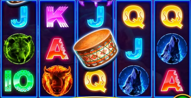 Native Spirit slot game screen featuring reels with symbols including wolves, buffalo, tribal drums, and traditional playing card icons illuminated in neon-style colors.