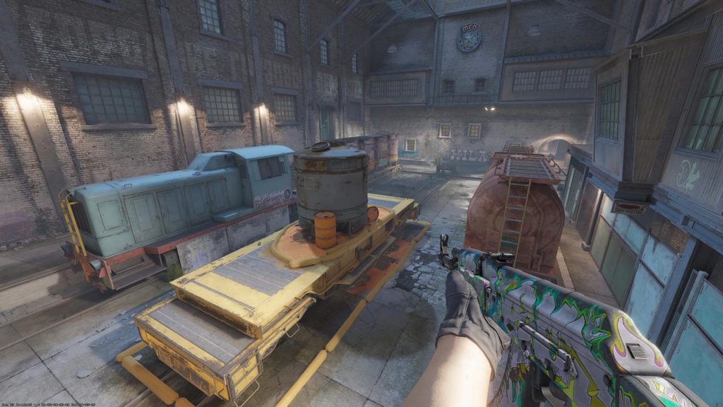 CS2 player holding an AK on a bombsite on the Train map.